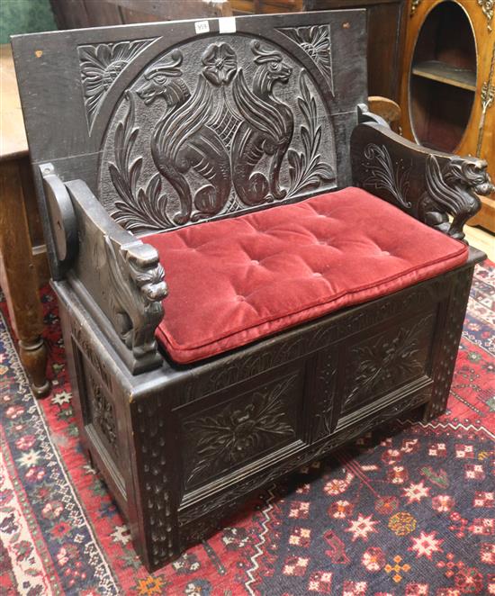 A small carved oak monks bench W.88cm